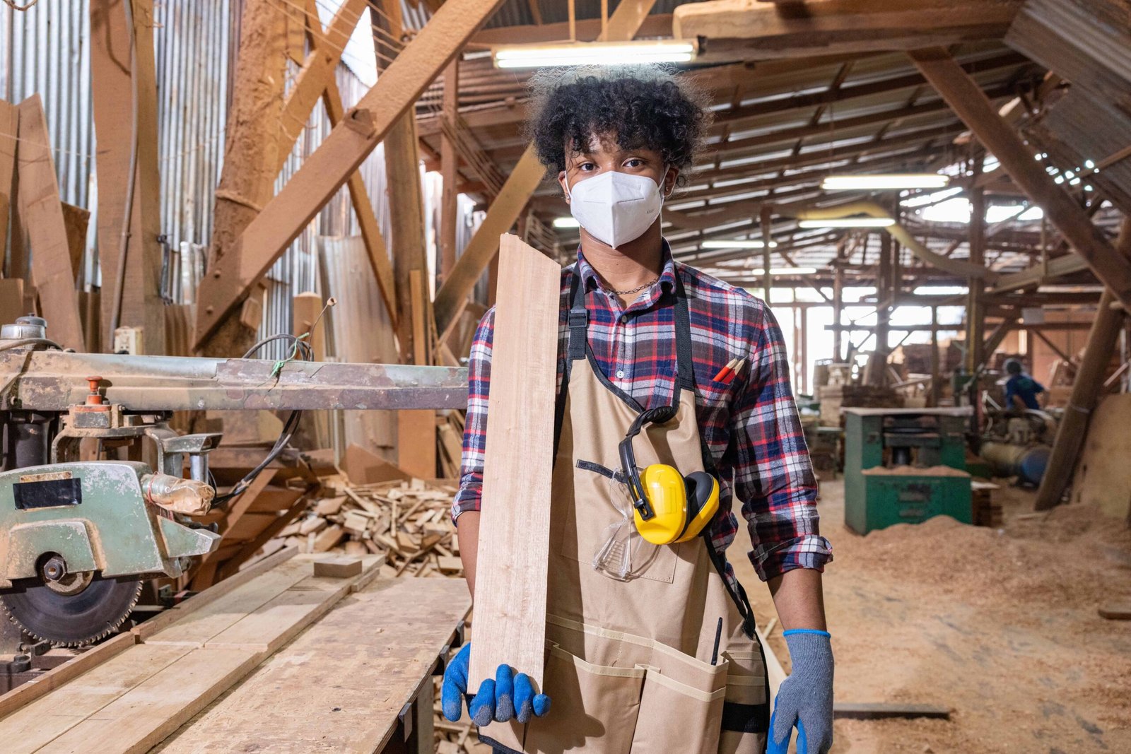 young-carpenter-holding-wood-plank-in-workshop-2025-09-08-13-10-17-utc